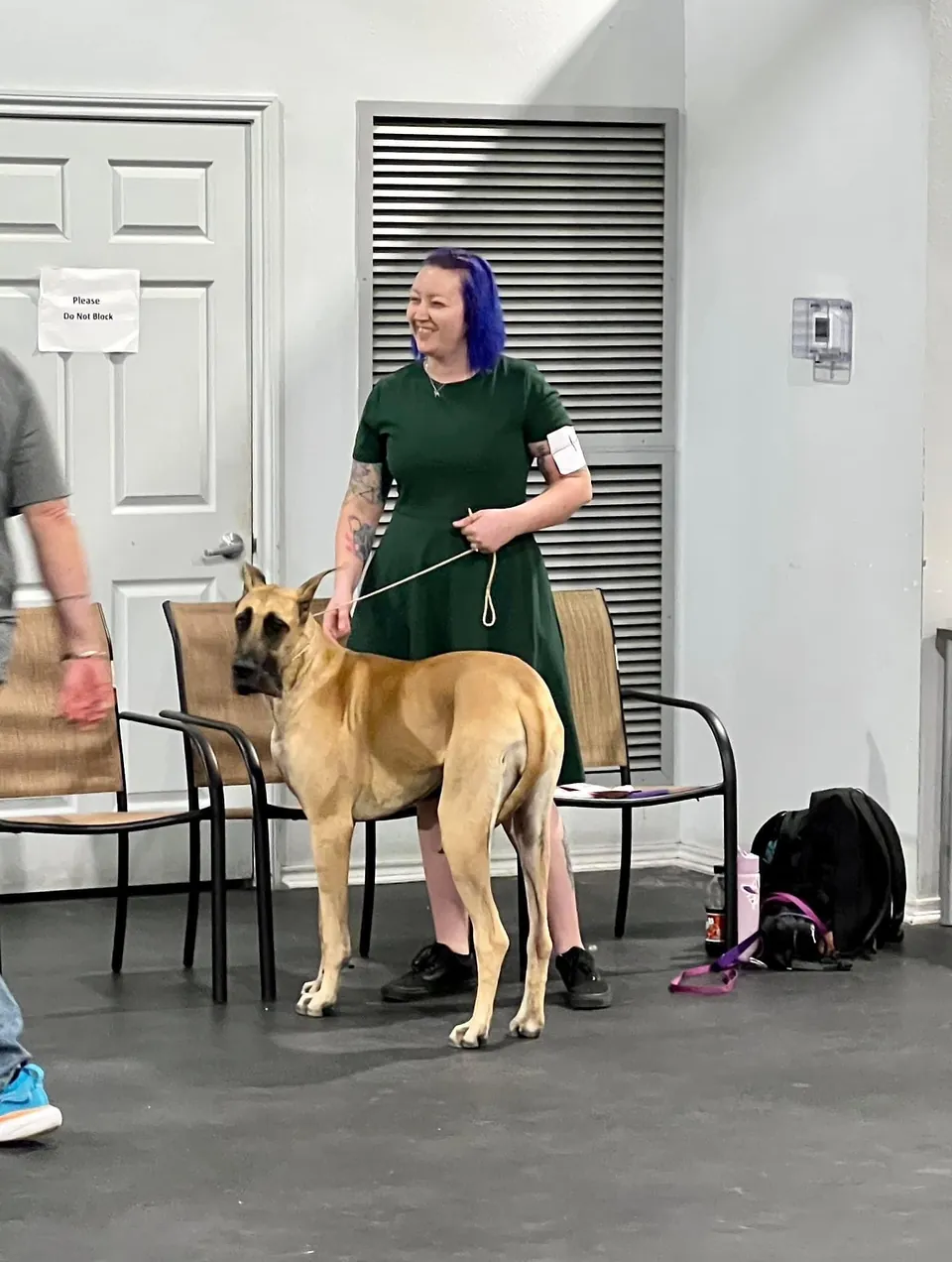 Phoebe standing with her owner at an event